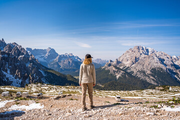 female hiker admiring the panorama view on mountains