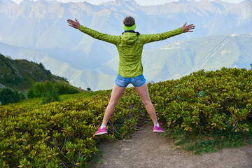 person jumping in the mountains
