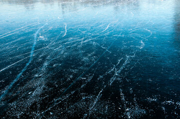 Abstract ice texture. Cracks in a piece of blue ice. Wave.