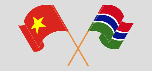 Crossed and waving flags of Vietnam and the Gambia