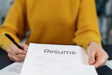 Woman working with cv resume in office