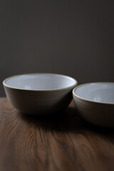 Empty ceramic bowl standing on wooden table