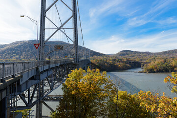 Purple Heart Memorial Bridge over the Hudson River with mountains in the background during Autumn.