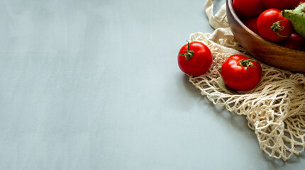 Healthy food vegetables on grey background. Groceries in recycle textile bags. Eco friendly plastic free low waste lifestyle. Zero waste bio food storage and shopping concept.