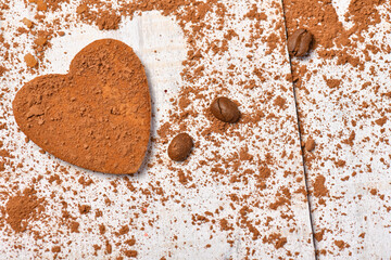 sweet food top view background for merry christmas or new year holiday decoration - coffee beans, heart shape from cocoa powder and cookie on white wood