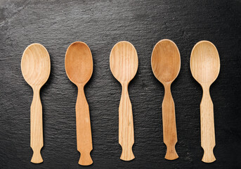 empty wooden spoons on a a black background