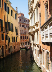 Fototapeta na wymiar Gondola in picturesque Venice Canal - Venice, Italy