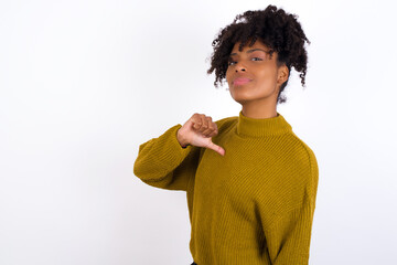 Closeup of cheerful Young beautiful African American woman wearing knitted sweater against white...