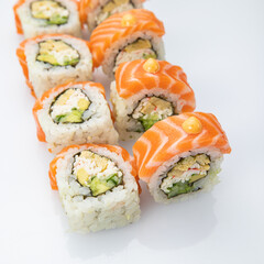 Japanese cuisine. Sushi roll with salmon on white background.