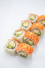 Japanese cuisine. Sushi roll with salmon on white background.