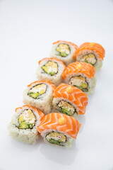 Japanese cuisine. Sushi roll with salmon on white background.