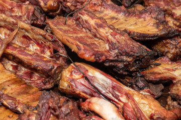 Bunch of smoked ribs on the heap. Homemade meat products.