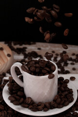 flying roasted coffee beans on a white classic espresso mug 