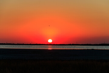 Beautiful orange sunset over a salt lake