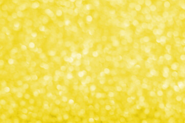 Illuminating Pantone Color Of The Year 2021. Abstract festive bokeh background with shining defocus sparkles. Blurred glitters shimmering dust macro close up, copy space for text logo