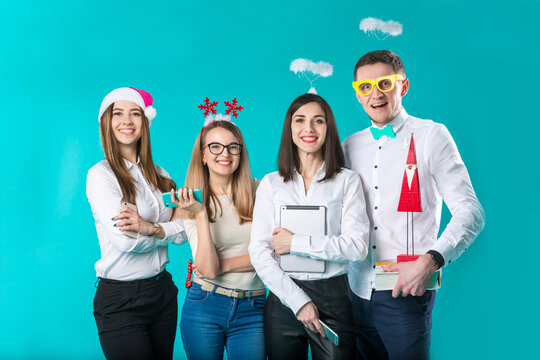 Business People Celebrating New Year Party And Christmas Celebration. Office Christmas Party. Group Colleagues Having Fun New Year Celebration. Co Workers Posing Funny Christmas Accessories In Studio