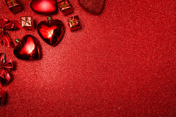 valentines day background, red hearts and gifts on red shiny background, top view