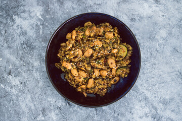 plant-based food,  vegan potato mushroom and zucchini stir fry with alomnds and sesame seeds