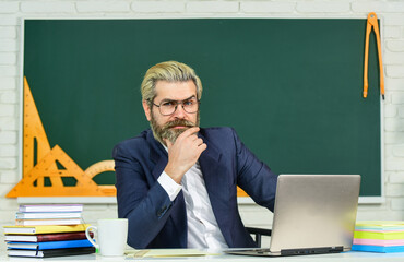 Digital technology enhances education. Senior teacher use laptop in class. Using computer technology. Computer and information technology. School and education. New technology. Modern life