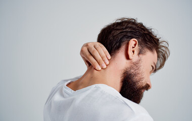 Fototapeta premium man touching his neck with his hand osteochondrosis back pain