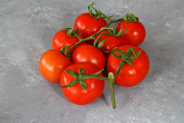 Cherry tomatoes isolated on a stone background. Close-up. Copy space.