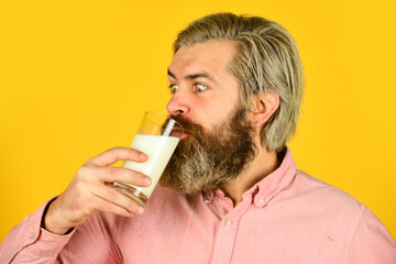 farmer present milk glass. bearded man drink useful milk. intestinal health concept. Useful and Vitamins. his favorite yoghurt. dairy production industry. vegan plant based milk