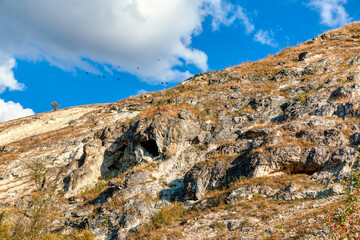Craggy hill against blue sky . Natural mountain rocks 