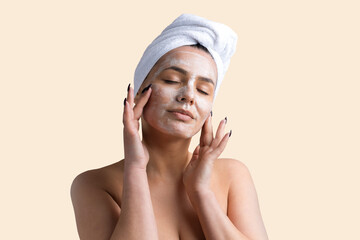 Beauty portrait of woman in white towel on head applies cream to the face. Skincare cleansing eco organic cosmetic spa relax concept.