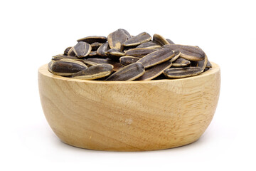 sunflower seeds in a wooden bowl isolated on white background