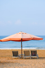 Beautiful umbrella and chair near The Mediterranean Sea in hotel. Resort - vacation concept. Summer holidays. Sand on the beach. Empty beach.