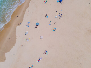 Aerial view of people sunbathing at beach