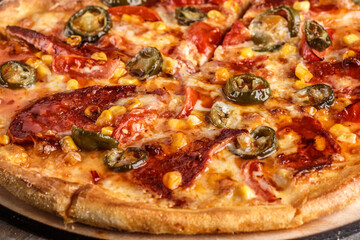 Fresh pizza with tomato sauce, black olives, mozzarella cheese, ham on wooden table closeup. Space for text or copy space. Pizza menu. Restaurant menu advertise