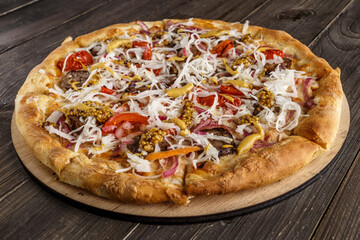Fresh pizza with tomato sauce, black olives, mozzarella cheese, ham on wooden table closeup. Space for text or copy space. Pizza menu. Restaurant menu advertise