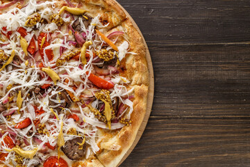 Fresh pizza with tomato sauce, black olives, mozzarella cheese, ham on wooden table closeup. Space for text or copy space. Pizza menu. Restaurant menu advertise