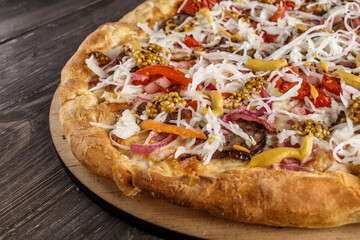 Fresh pizza with tomato sauce, black olives, mozzarella cheese, ham on wooden table closeup. Space for text or copy space. Pizza menu. Restaurant menu advertise