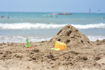 Sand Castle on the seaside. Summer fun and activity on the Beach. Mediterranean sea. Playing with Sand. 