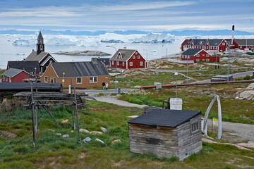 Colorful buildings overlook Disko Bay in Ilulissat, Greenland. Sites include Zion's Church, the red...