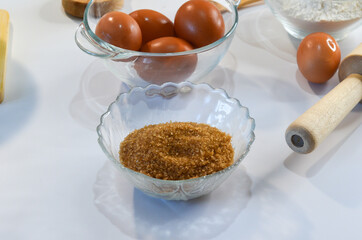 baking ingredients, eggs, flour and brown cane sugar, quarantine home baking concept, food background