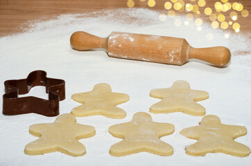 Raw gingerbread prepared for baking, spread on top of the flour. Selective focus