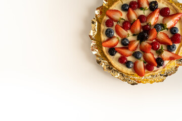 Fruit cake with strawberries and cranberries for christmas dinner in white background with empty space