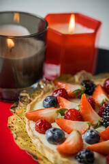 close up of handmade cake recipe from the family with candles laying on a table for christmas