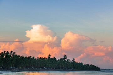 A beautiful sunrise with huge colorful clouds above the ocean in Mexico