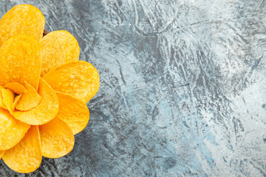 Half shot of potato chips decorated like flower shaped in a brown bowl on gray background stock image