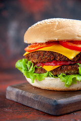 front view meat burger with cheese salad and tomatoes on dark background sandwich meal buns