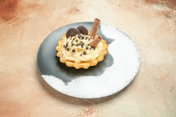 front view little delicious cake inside plate on a light background pie cake dessert sweet