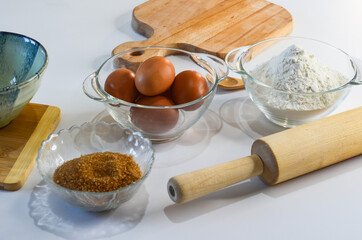 Fototapeta na wymiar baking ingredients, eggs, flour and brown cane sugar, quarantine home baking concept, domestic life