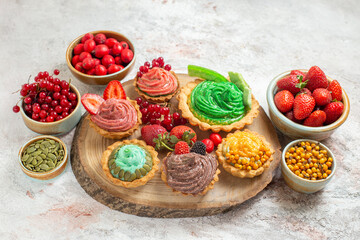 front view creamy cakes with fruits on white background sweet dessert biscuit
