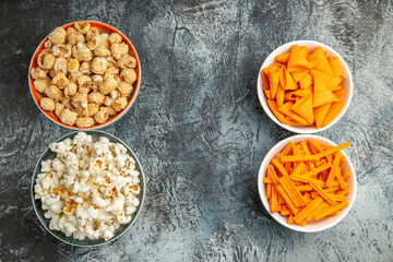 top view different snacks popcorn rusks and cips on a light background snack movie cinema