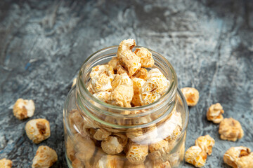 front view sweet popcorn inside glass can on light background snack movies sugar