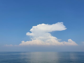 Bright blue sky and white clouds with the sea below is the beauty of nature. The atmosphere of the sea, the sky is calm, with less waves, suitable for relaxation.
